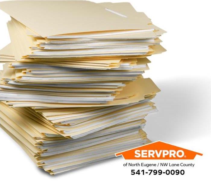 A stack of business files is shown.