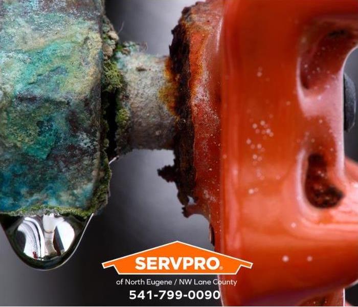 A corroded water valve is dripping water.